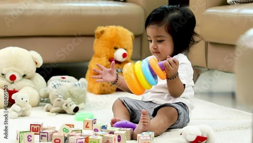 Stock video of a baby boy playing with his toys at home.