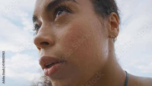 Face, sweat and fitness with a sports woman breathing while feeling tired after an exercise or workout. Exhausted, sweating and thinking with a female employee out of breath during cardio training photo