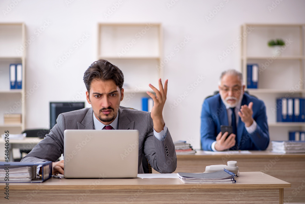 Two male colleagues working in the office Two male colleagues working in the office