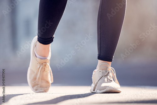 Athlete woman, running and shoes on street for fitness, workout and training outdoor in summer sunshine. Runner girl, sneakers and exercise on city road, ground or metro for health, wellness or sport