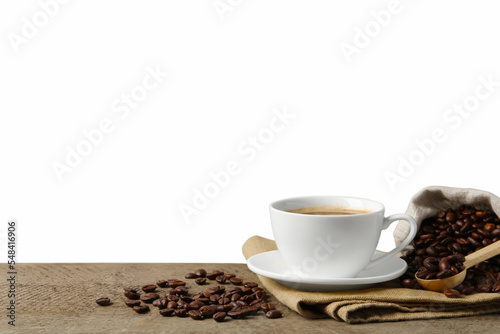 Cup of aromatic coffee and beans on wooden table against white background