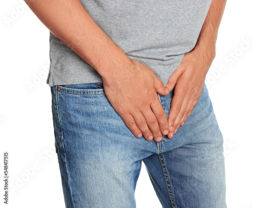 Man suffering from genital herpes on white background, closeup
