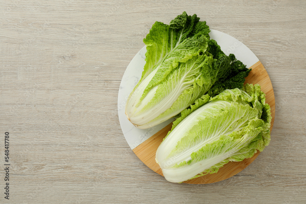 Fresh ripe Chinese cabbages on white wooden table, top view. Space for text Fresh ripe Chinese cabbages on white wooden table, top view. Space for text