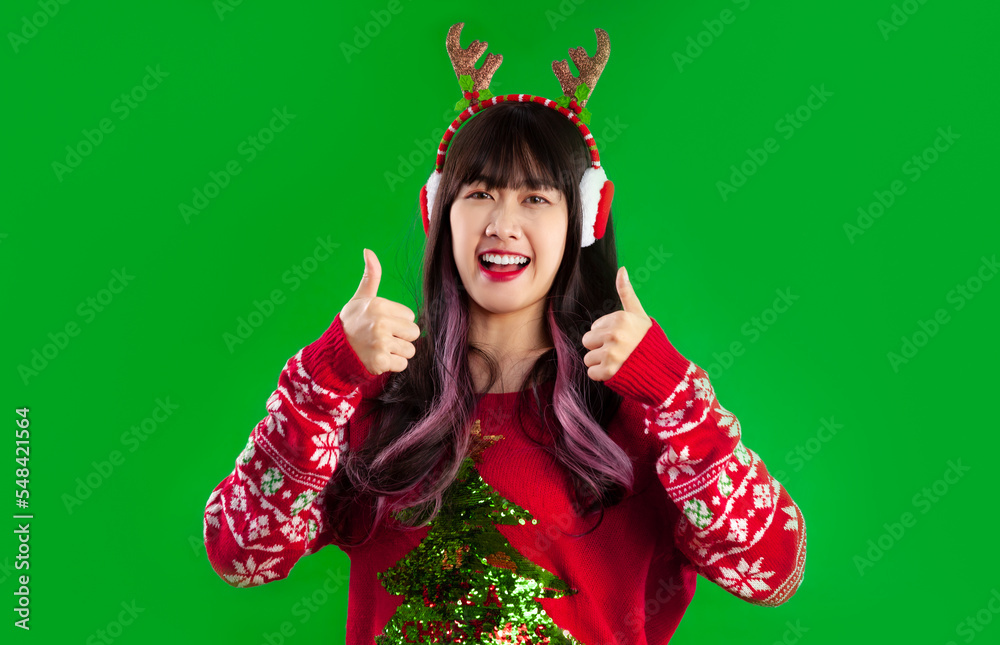 Merry Christmas young asian woman long hairstyle in red sweater looking camera posing thump up on green screen background. Merry Christmas young asian woman long hairstyle in red sweater looking camera posing thump up on green screen background.