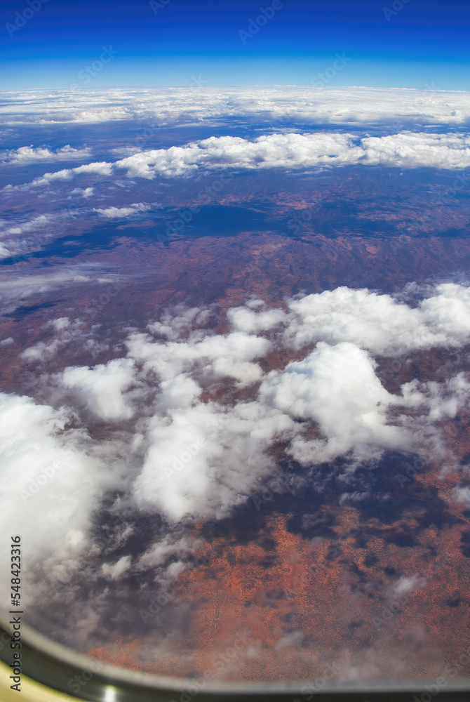 The Australian Outback as seen from the airplane window. Clouds in the sky