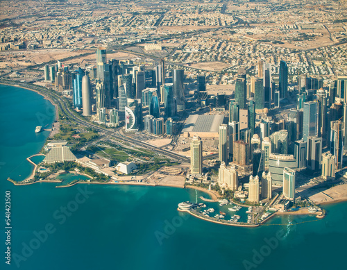 Aerial view of Doha skyline from airplane. Corniche and modern buildings, Qatar