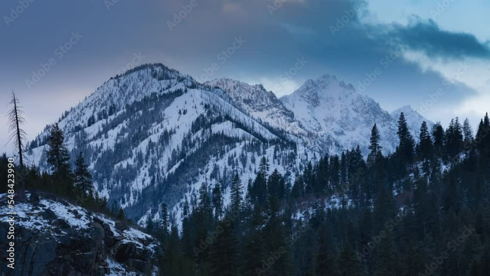 Time-lapse of clouds swirling over mountain peaks at sunset. Shot in 4K Time-lapse of clouds swirling over mountain peaks at sunset. Shot in 4K