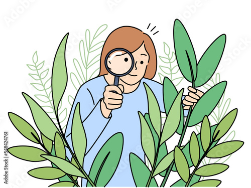 Woman botanist with magnifier look at plants Fototapet