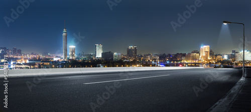 Cairo street at night in Egypt - road in Cairo city with buildings and Cairo tower in Background - 