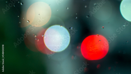 Fototapeta Naklejka Na Ścianę i Meble -  Defocused abstract background of colorful light in the rain