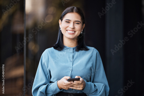 Business woman, portait and smile with phone typing, happy to email or doing online, internet or web search. Career female with mobile smartphone working in social media marketing outdoor in the city photo
