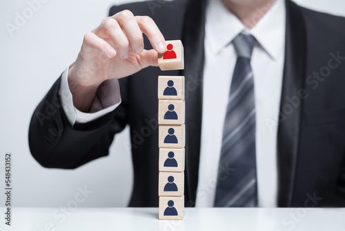 Wooden blocks with people icons, businessman hands holding cude, leadership, carieer, business concept photo