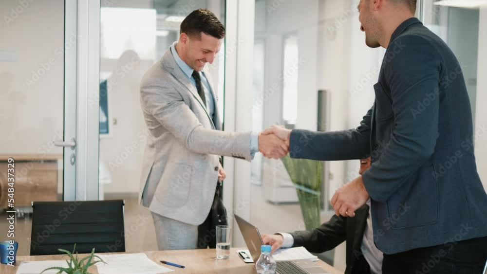 Businessman comes to a business meeting and greets colleagues Businessman comes to a business meeting and greets colleagues