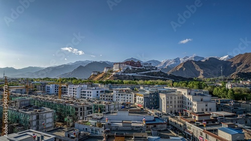 Ancient Potala Palace on a hill from the buildings in Lhasa, Tibet,China photo