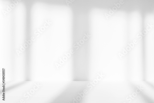 Fototapeta Naklejka Na Ścianę i Meble -  Abstract white studio background for product presentation. Empty room with shadows of window. Display product with blurred backdrop.