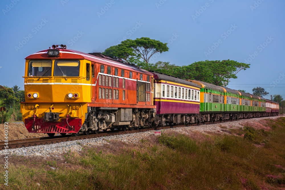 Passenger train by diesel locomotive on the railway.