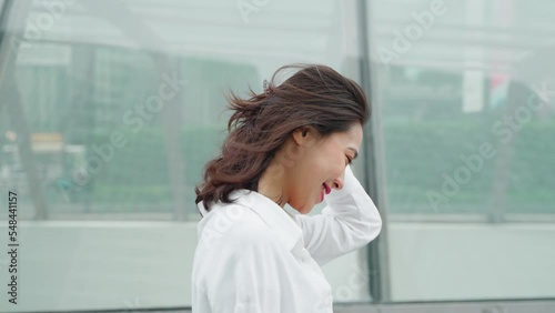 side view slow motion happy young asian woman walking in the urban city confident business woman