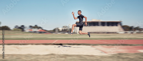 Runner, man jump and sports stadium for marathon training, fitness workout or wellness exercise on track. Athlete, speed and running energy or jumping for olympics high jump performanc and challenge