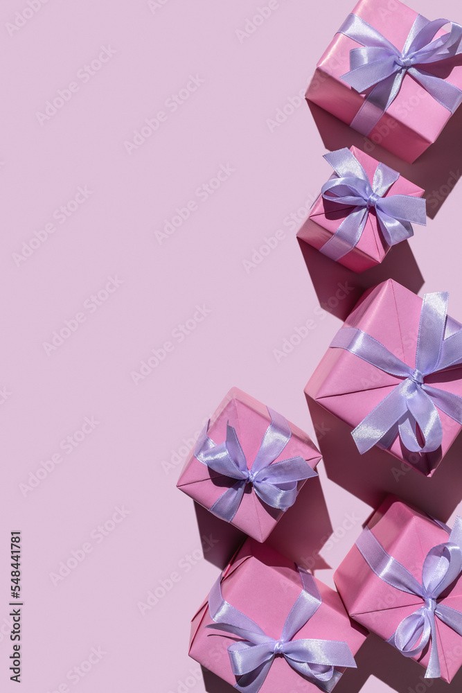 Gifts in modern, stylish boxes on a delicate pink background. Holiday concept, copy space. - obrazy, fototapety, plakaty 