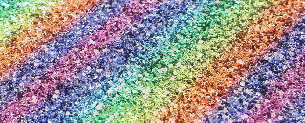 glitter pastel lights background. red, gold, purple, green and blue. de-focused