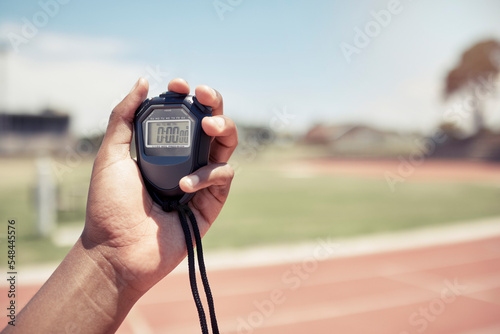 Sport, coach and closeup of hand with stopwatch for time, training and speed of athlete, runner or race. Mentor, trainer and digital clock, watch or timer for fast running on track, field or stadium