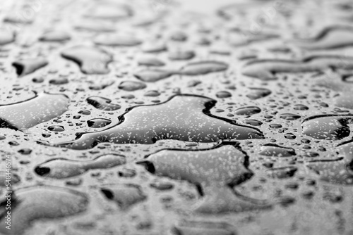 water drops at a structered grey surface, depth of field background
