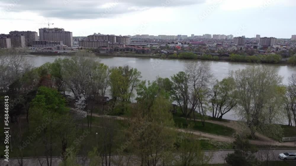 KRASNODAR, RUSSIA - APRIL 24, 2021: The Kuban River and residential buildings on the other side of the river. 4K. KRASNODAR, RUSSIA - APRIL 24, 2021: The Kuban River and residential buildings on the other side of the river. 4K.