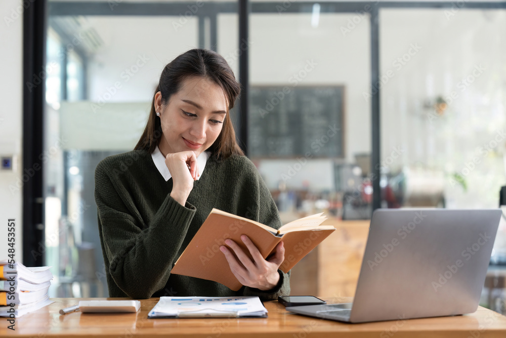 studying remotely from home, using a laptop, taking notes on notepad during online lesson, e-learning concept, smiling studying remotely from home, using a laptop, taking notes on notepad during online lesson, e-learning concept, smiling
