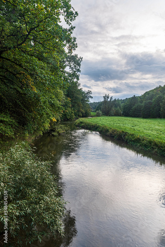 River with meadow and trees around - Weisse Elster river near Plauen city in Germany photo