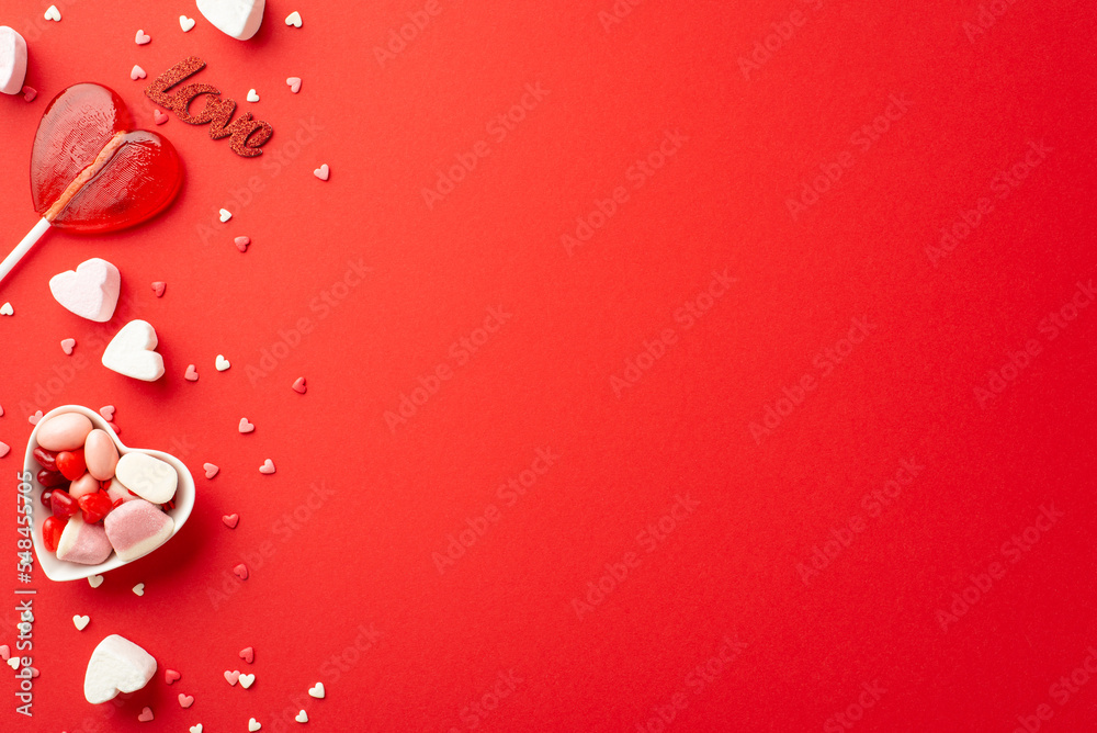 Valentine's Day celebration concept. Top view photo of heart shaped saucer with jelly candies lollipop inscription love and confetti on isolated red background with blank space