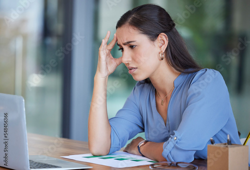 Business woman, laptop and stress with headache from work anxiety or technical problems at the office. Female employee analyst suffering from burnout, depression or mental health issues at workplace