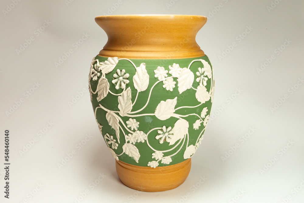 ceramic vase with floral carvings on a white background ceramic vase with floral carvings on a white background
