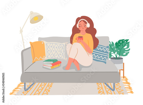 People home hobby, girl sitting on sofa with tea and book