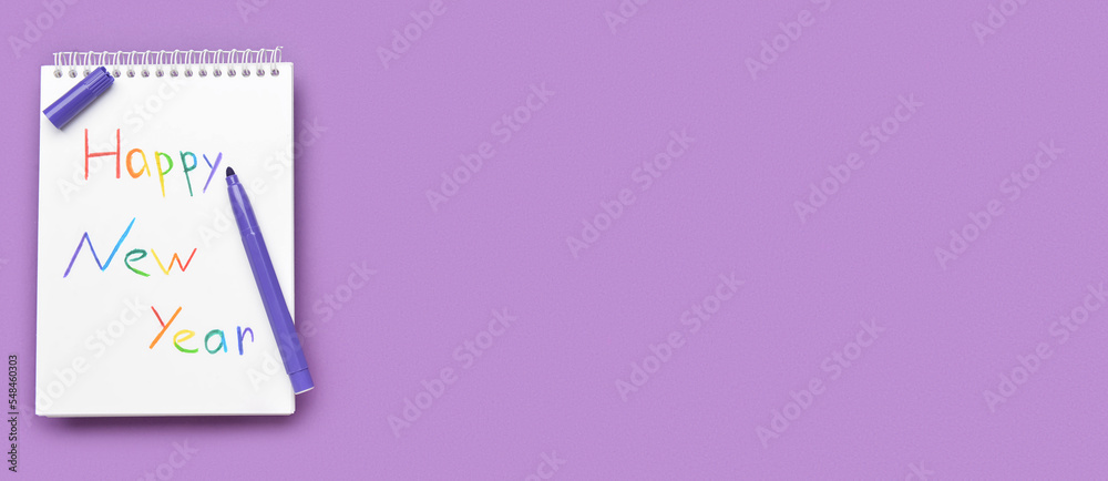 Notebook with written text HAPPY NEW YEAR and marker on purple background with space for text. LGBT concept