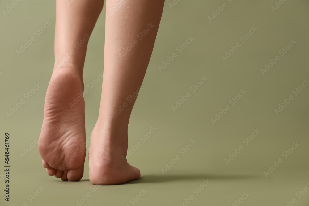 Female barefoot legs on color background Female barefoot legs on color background