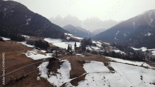 Aerial of St Magdalena winter village in Dolomiti mountain background photo