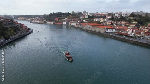 Rabelo boat sailing on Douro River, Porto, Portugal. Aerial flying forward photo