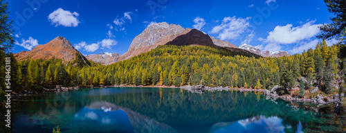 Fototapeta Naklejka Na Ścianę i Meble -  The saoseo lake with its spectacular colors and the swiss alps with the autumn light, near the village of Poschiavo, Switzerland - October 2022.