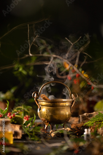 Christmas mulled red wine with spices and fruits on a wooden rustic table. Traditional hot drink at Christmas time