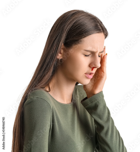 Young woman with nosebleed on white background