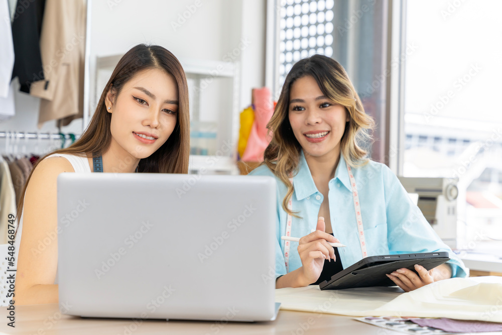 Two Asian women working together Small business, SME, tailoring designs for customers. Both of them acted as great designers. Two Asian women working together Small business, SME, tailoring designs for customers. Both of them acted as great designers.