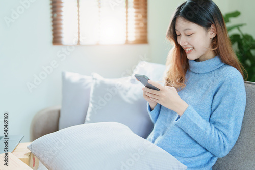 Portrait of a beautiful Asian teenage girl using a smartphone mobile