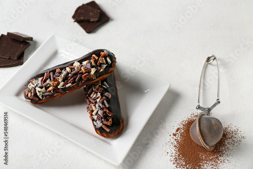 Two chocolate eclairs with ...