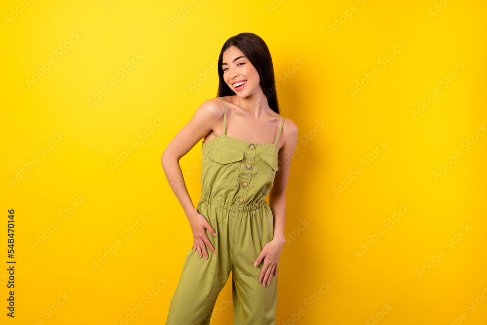 Photo of cute adorable young lady wear green outfit smiling isolated yellow color background Photo of cute adorable young lady wear green outfit smiling isolated yellow color background