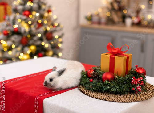 Cute rabbit on a table decorated with Christmas decorations