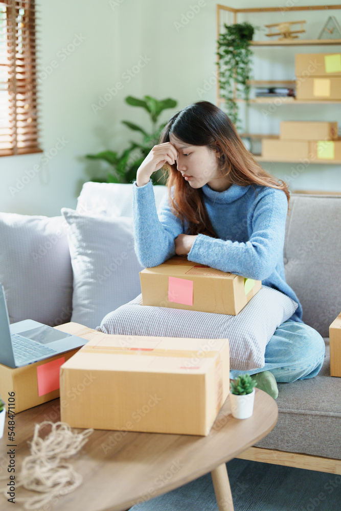 Starting small business entrepreneur of independent Asian woman showing her face worried about the sales of her business not reaching the target set. SME concepts Starting small business entrepreneur of independent Asian woman showing her face worried about the sales of her business not reaching the target set. SME concepts