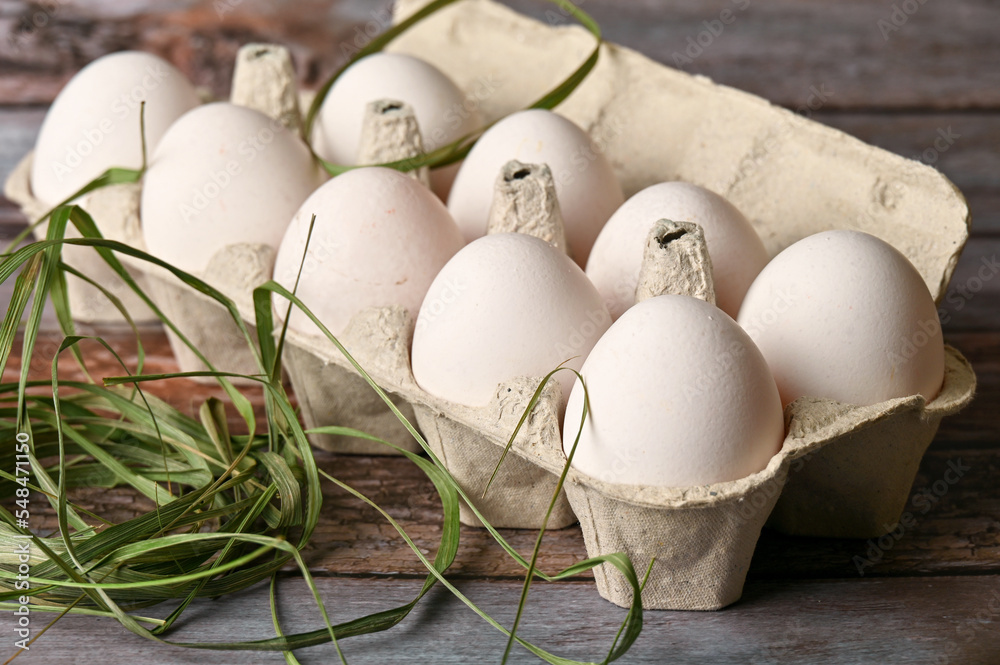 Chicken eggs lie on a wooden table in the kitchen Chicken eggs lie on a wooden table in the kitchen
