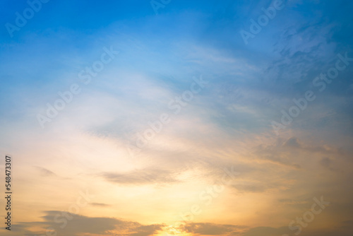 Beautiful cloudy sky after the rain between the sunset in gradient blue and yellow color tone.  © DG PhotoStock