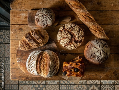 Top view of different types of sourdough bread on a wooden board