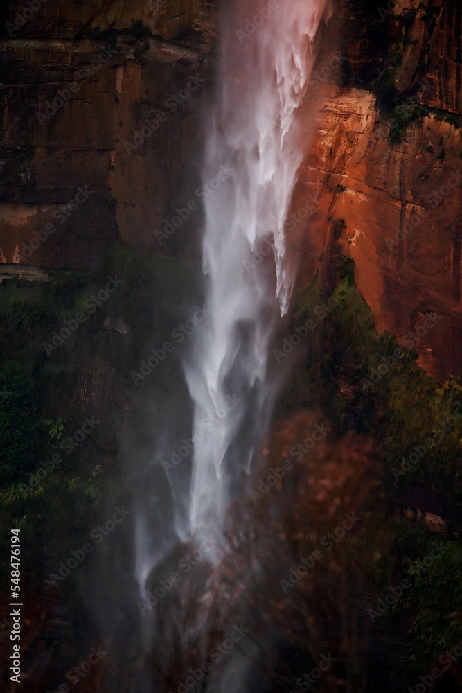 Powerful waterfall tumbling over sandstone cliffs